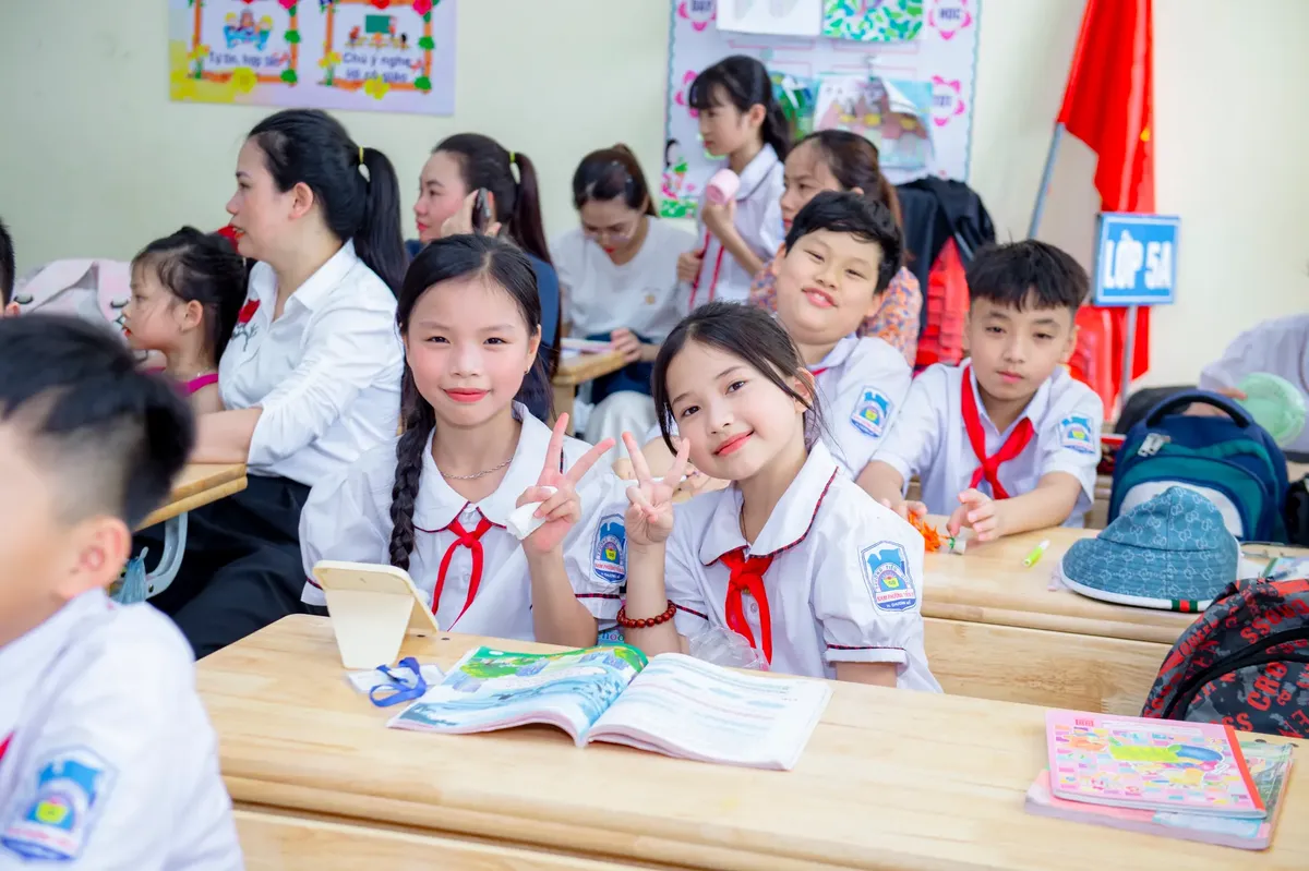 Primary school students seated in a classroom in Hanoi, Vietnam, engaging in learning and interaction.