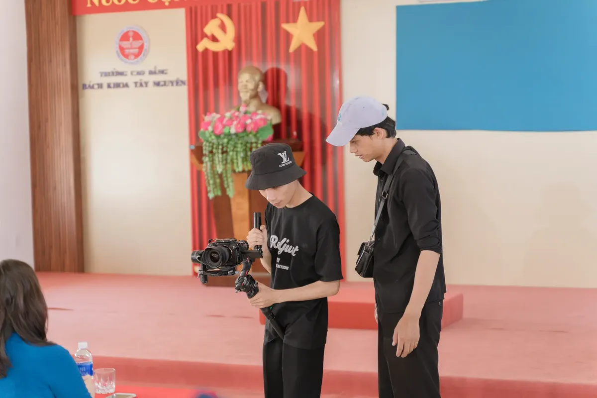 Two young filmmakers cover an event at a college in Buôn Ma Thuột, Vietnam.